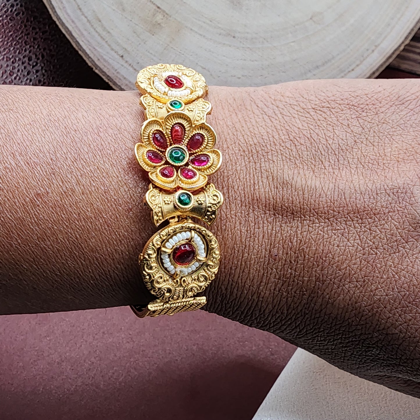 Radiant Floral Elegance: Gold-Tone Bracelet with Ruby and Emerald Accents